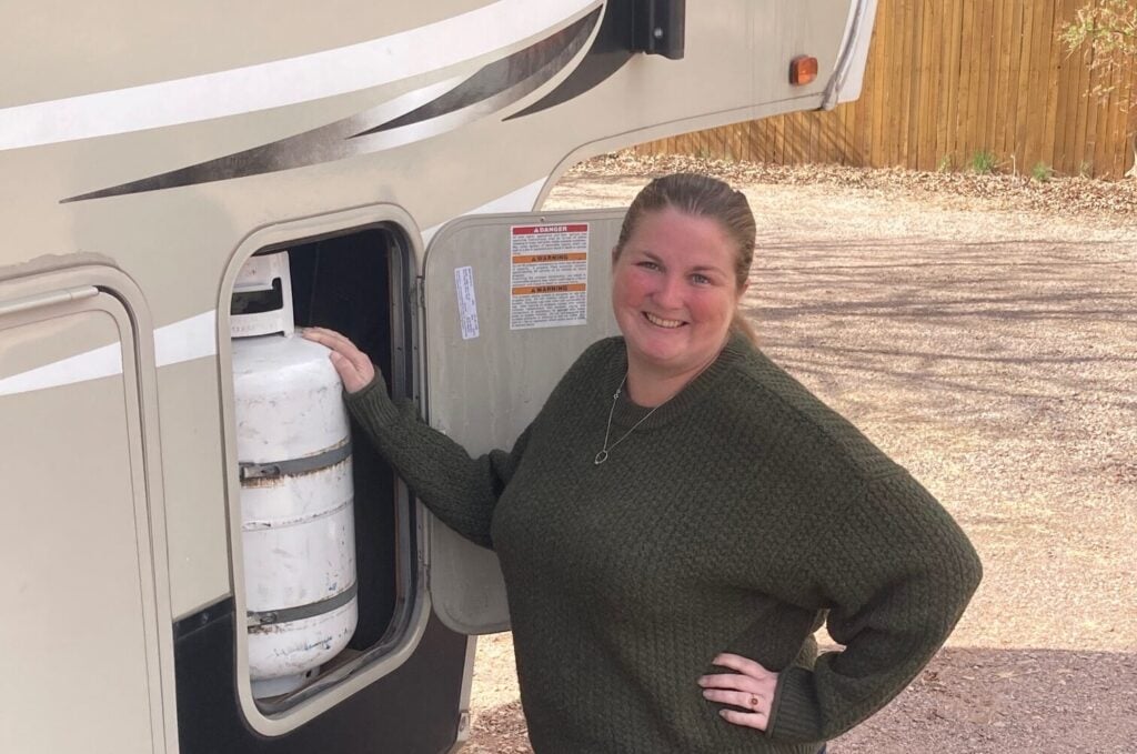 Woman standing by RV Propane Tank