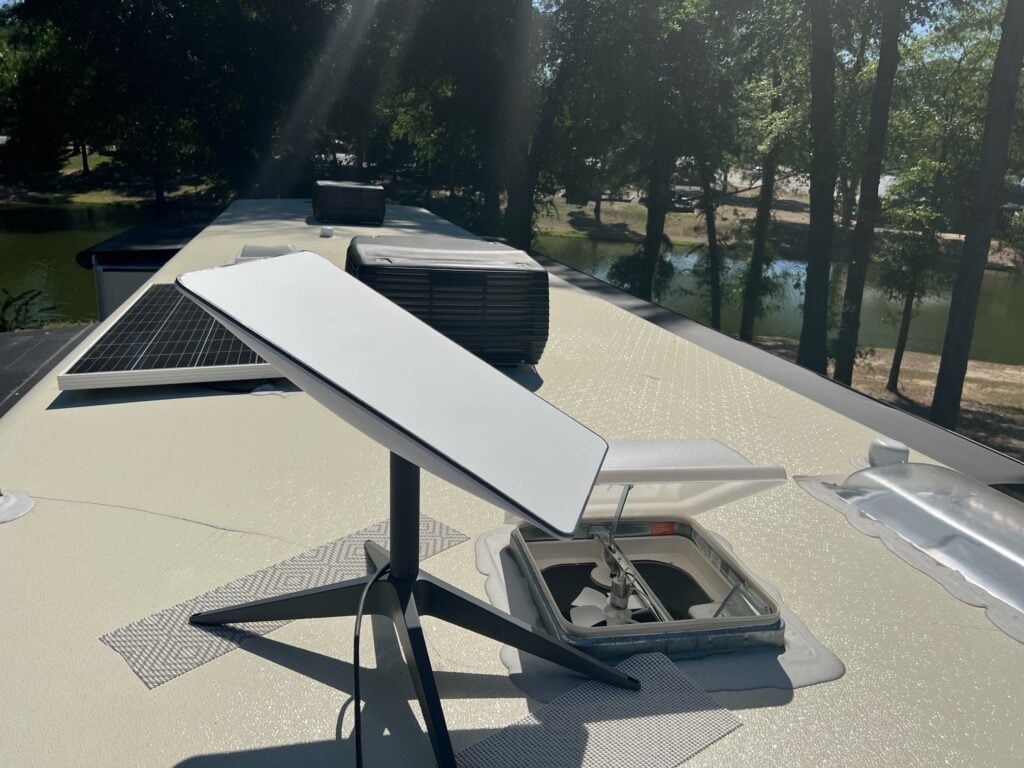 Starlink internet satellite dish on top of RV roof.