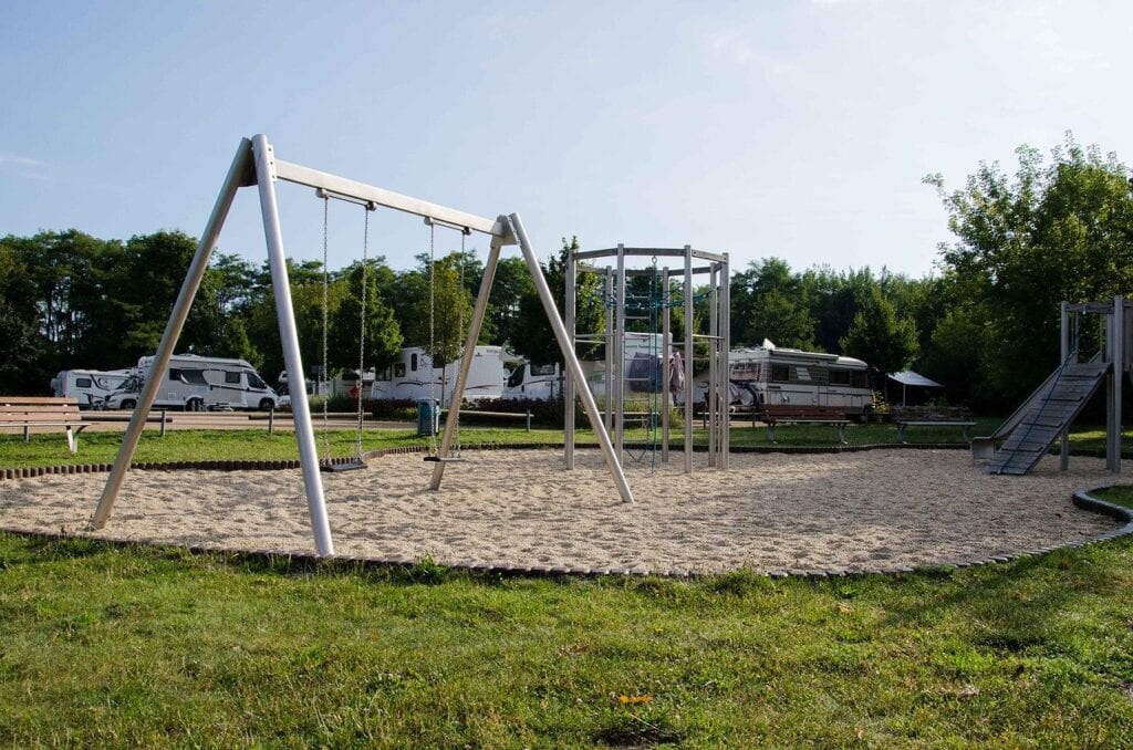 Free city RV park with playground in foreground. Cheap RVing destination.