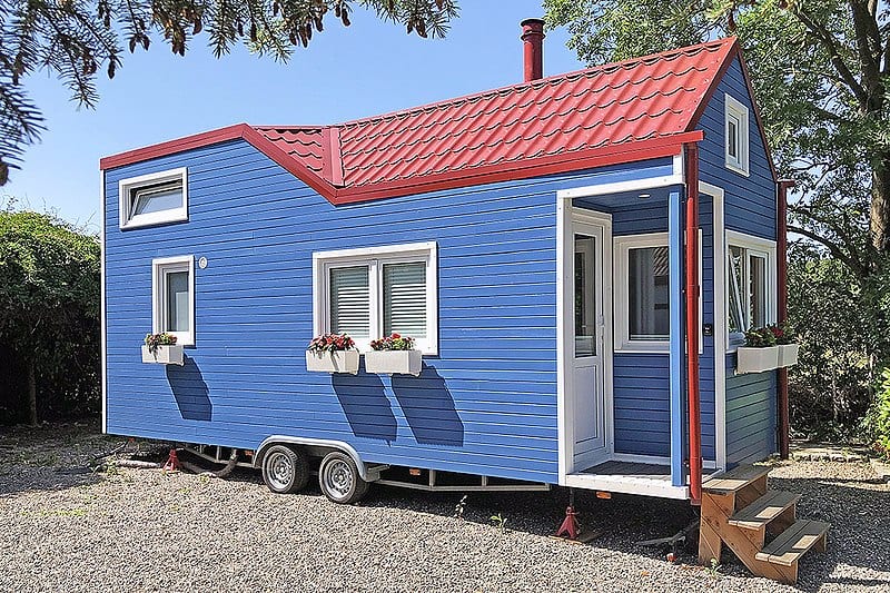 Blue Tiny house with a red roof