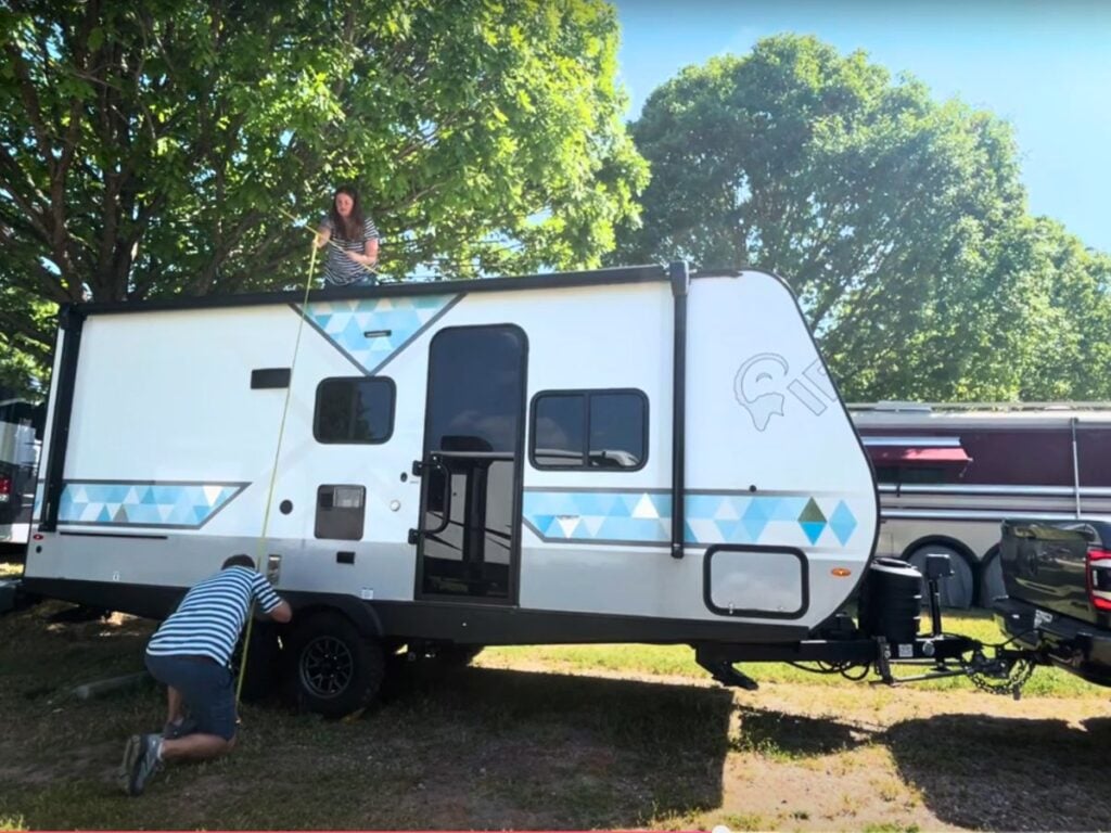 Woman and man measurign height of RV