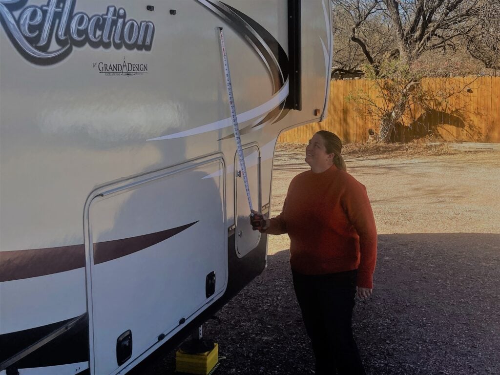 Woman Measuring How Tall an RV Is