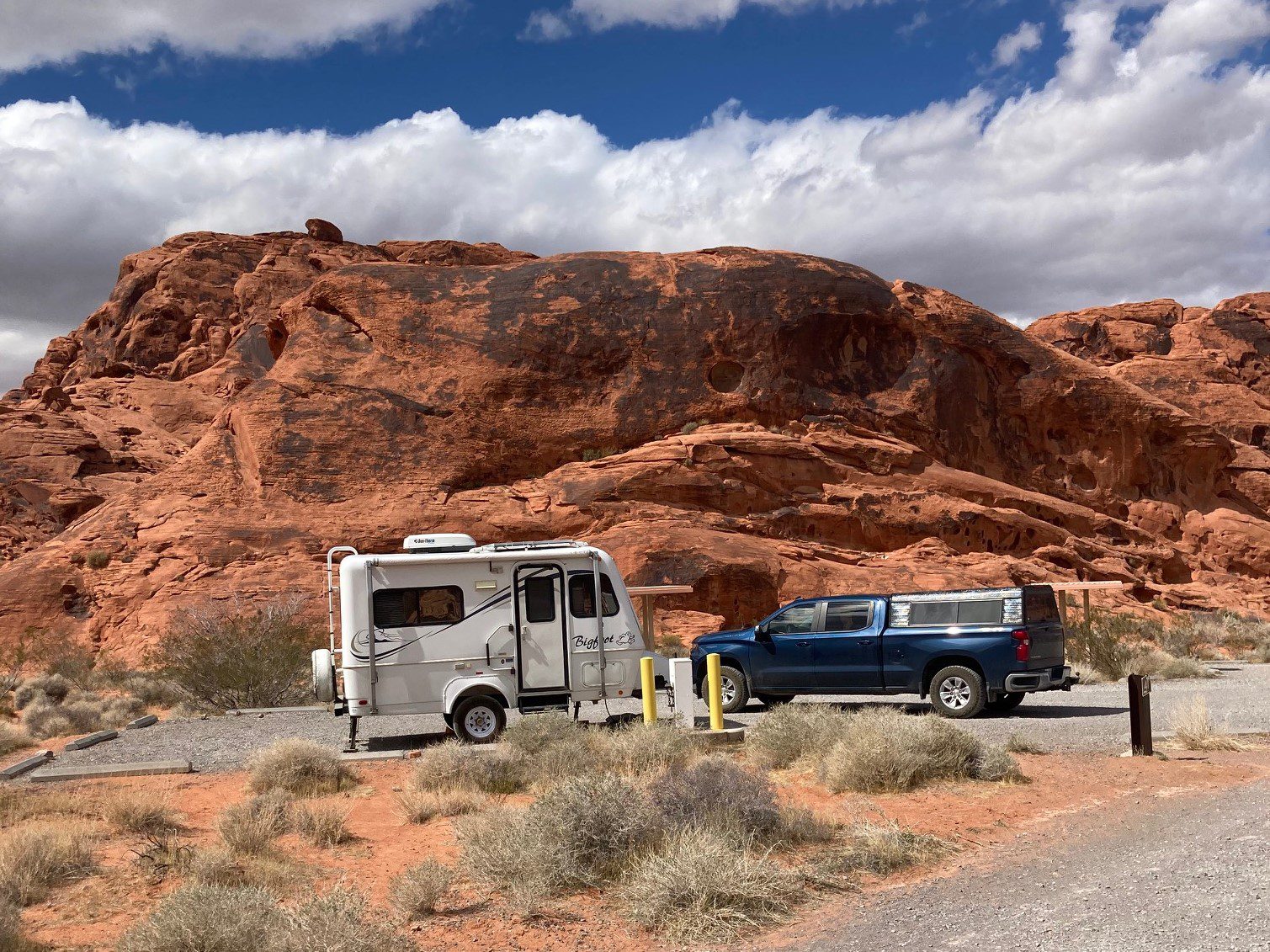 Small Travel Trailer in Campsite Surrounded by Red Rocks