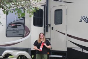 Woman holding fire extinguisher outside RV