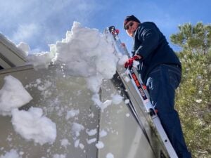 Tips for RV Camping in Cold Weather: Use A Broom to Remove Snow