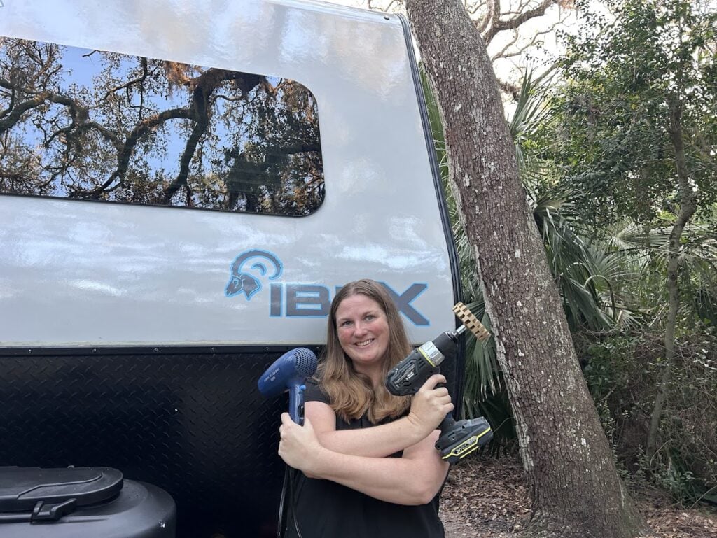 Woman hold RV decal removal tools