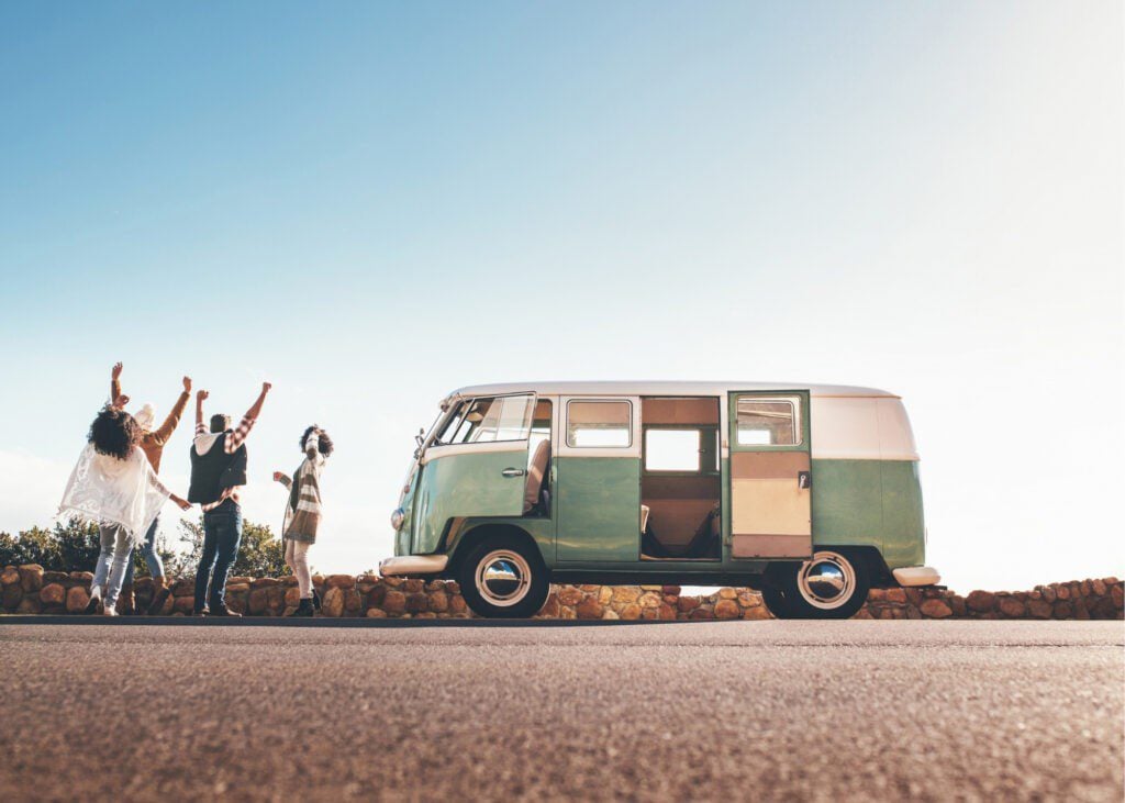 Friends cheering outside RV van.