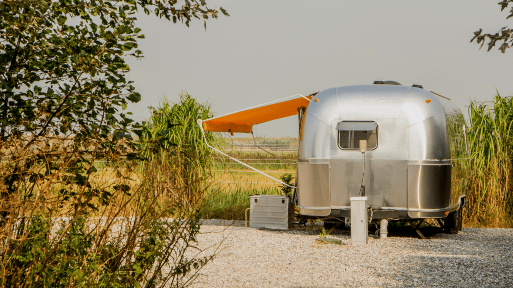 Airstream RV with orange awning.