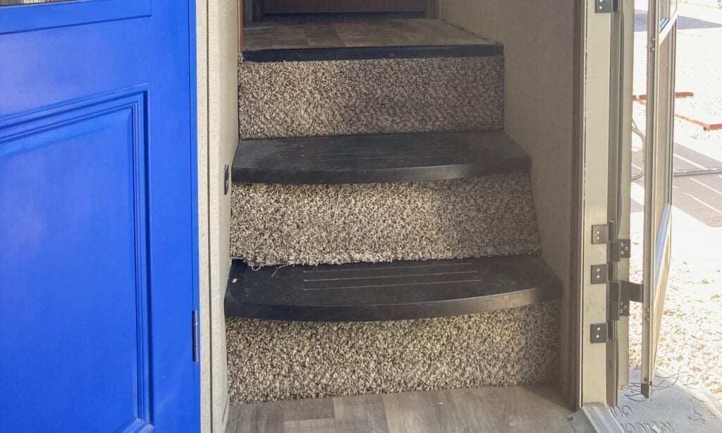 RV interior staircase and closet door painted blue