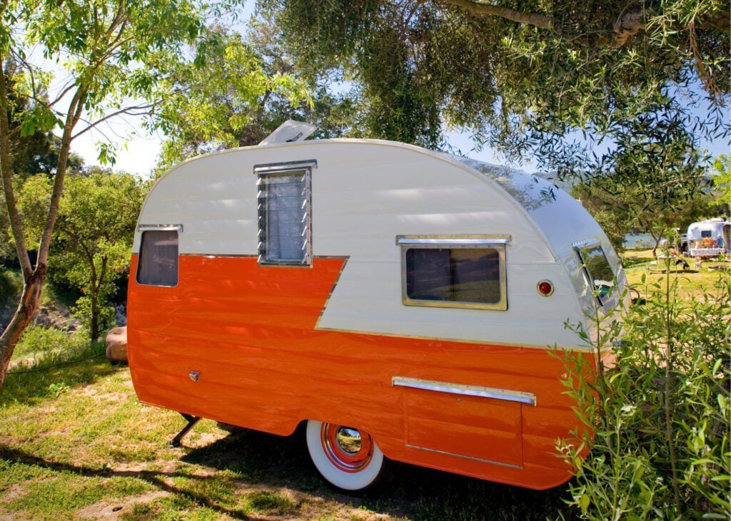 Cute vintage orange RV travel trailer for RV names article.