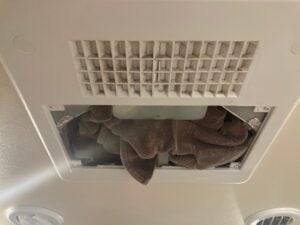 Cleaning RV Air Conditioners: Stuff Towel in Place of Air Filter to Collect Debris