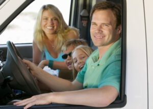 Dad driving RV with kids and mom