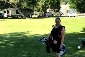 Woman with golf bag at RV park