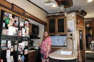 Full time RV living woman cooking inside RV.