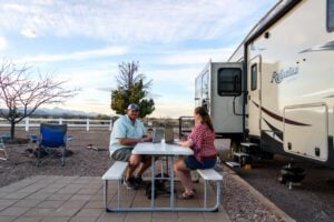 Couple searching from laptop at RV