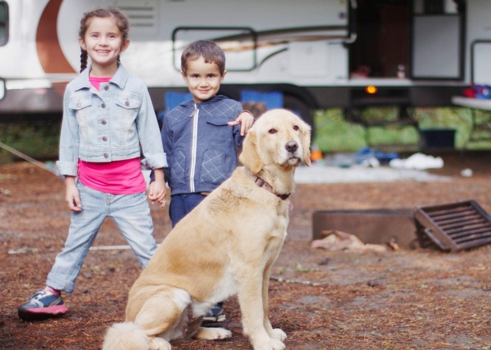 Kids and dog in front of RV