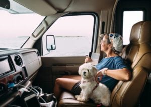 Dog riding with woman in RV