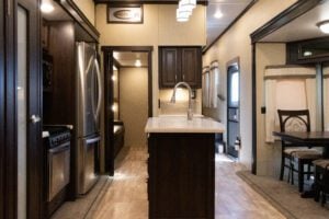 Residential refrigerator and kitchen inside RV.