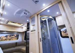 RV interior with bathroom door open showing shower. 