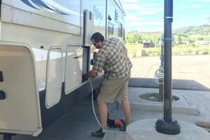 Man filling RV fresh water tank