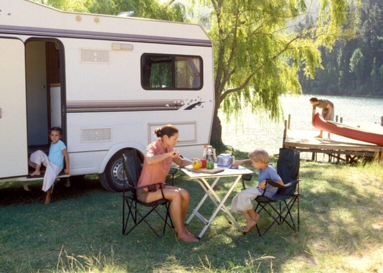 Family eating lunch at campsite.