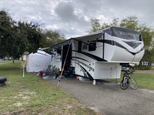 Fifth wheel RV parked on RV campsite.