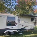 RV parked under trees in fall