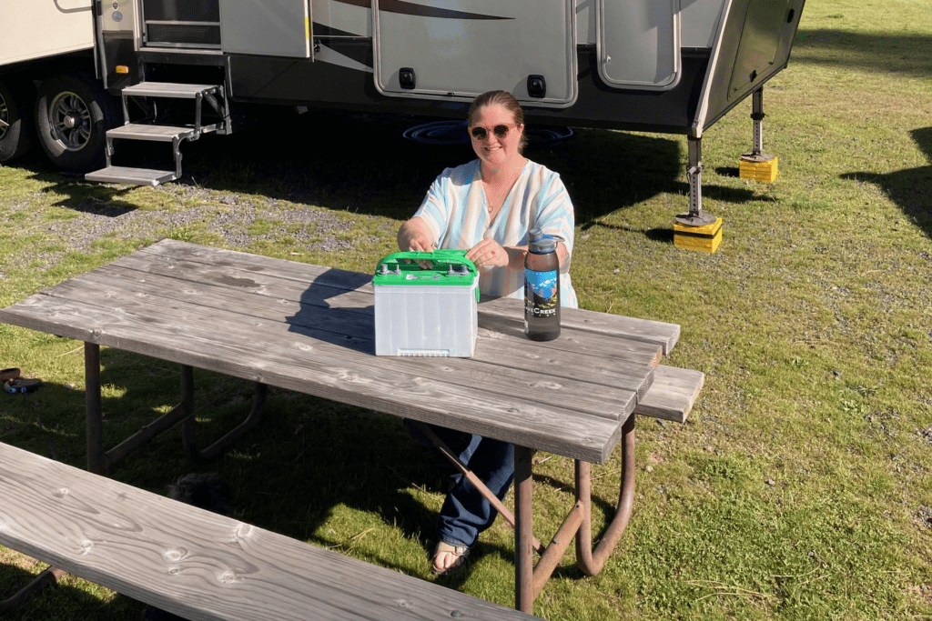 Woman putting water in RV lead-acid battery