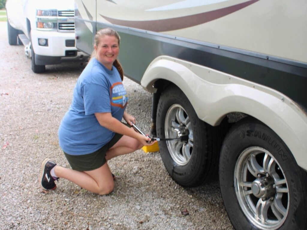 Woman using torque wrench on RV tires
