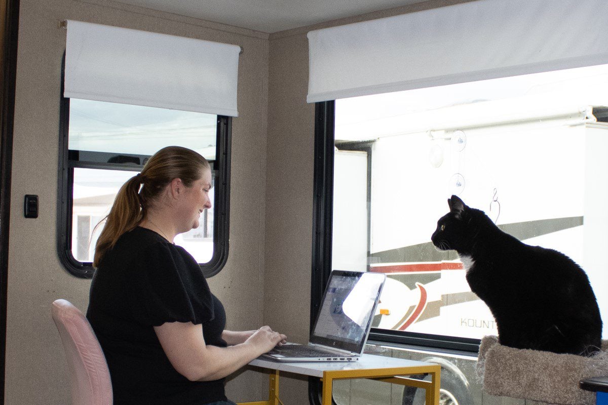 RV Modifications for Cats Woman at Desk with Cat and Cat Condo in an RV