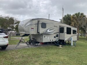 Fifth wheel RV with for sale sign on window