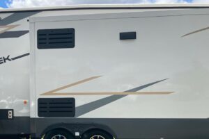 Clean refrigerator vents on RV exterior.