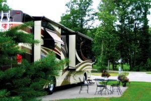 Luxury RV Resorts in Michigan. Campsite with Patio Furniture and RV at Thunder Bay Resort RV Park.