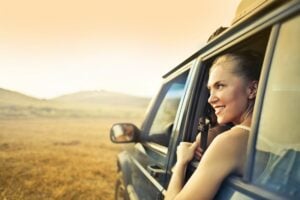 Woman in van looking out window. 