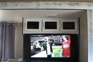 TV with sports content on inside RV camper.