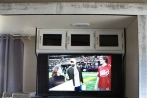 TV with sports content on inside RV camper. 