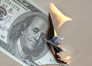 Dollar bill on fire. 