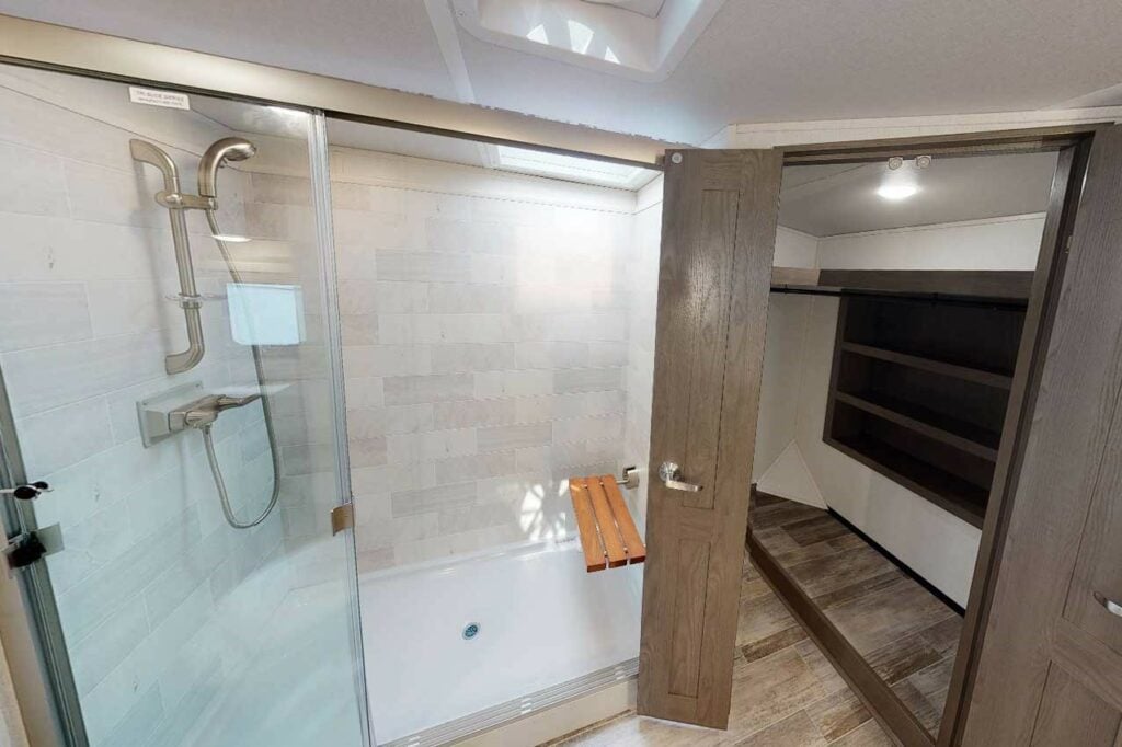 Oversized shower and closet in RV bathroom.