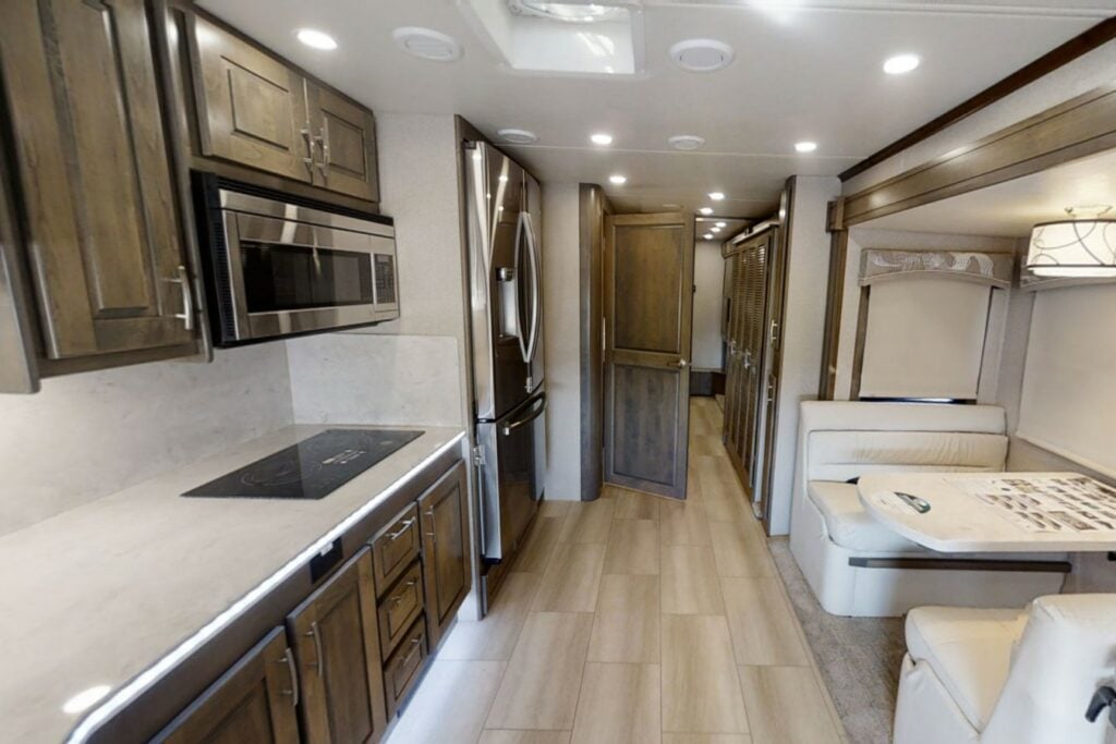 Kitchen and dining area inside a Super C RV motorhome.
