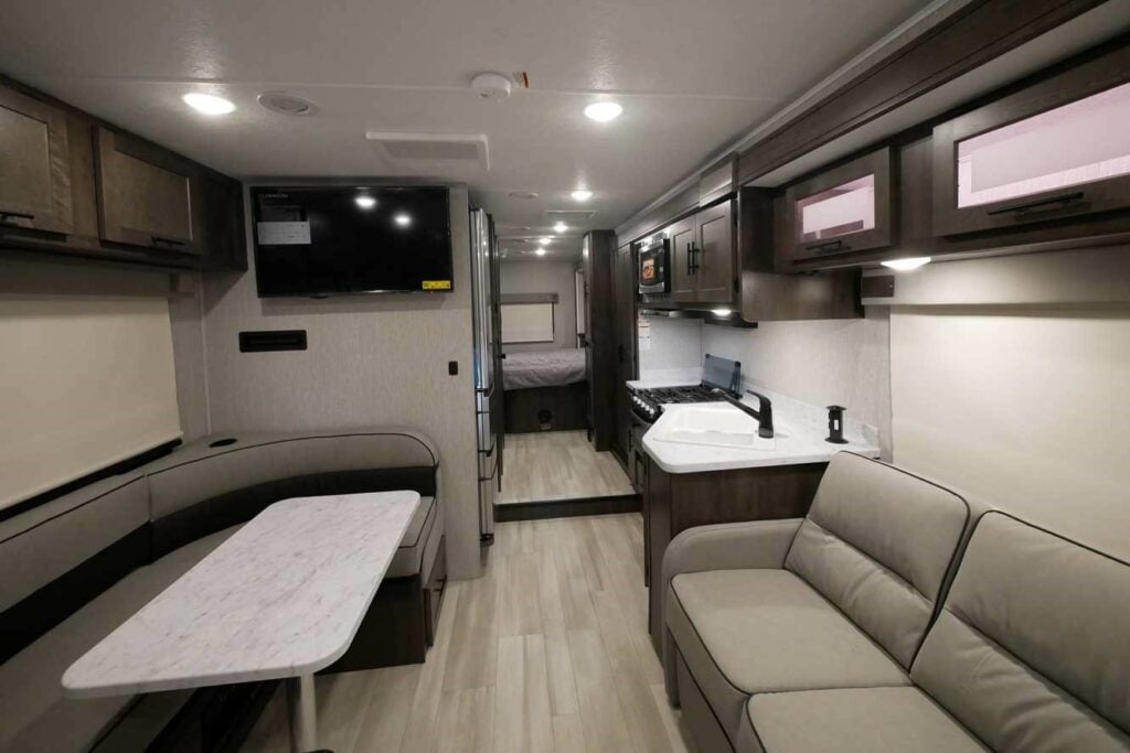 Living, dining and kitchen area inside a Class C RV. 