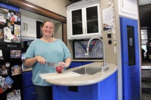 Woman Chopping Food in RV Kitchen