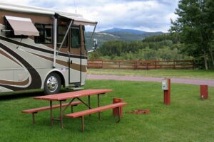 Class A RV at grassy campsite.