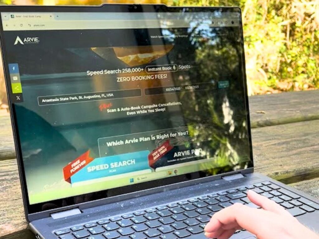 Arvie website on laptop screen. Laptop is sitting on picnic table.