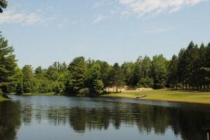 Lake surrounded by trees at Maine campground.