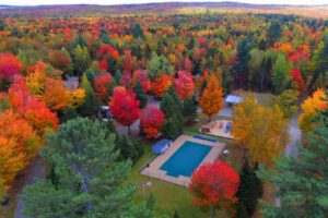 RV park shot from above with pool and autumn colored trees.