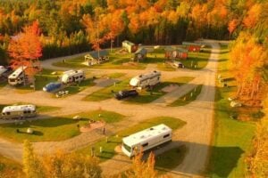 Aerial view of a KOA campground surrounded by fall trees. 