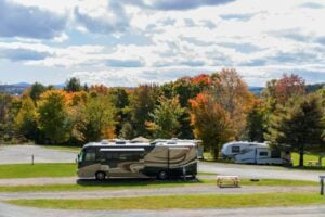 RV campground with trees in background.