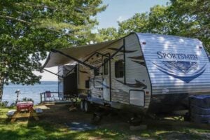 Travel trailer parked at waterfront RV campsite.