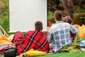 Friends watching movie while camping