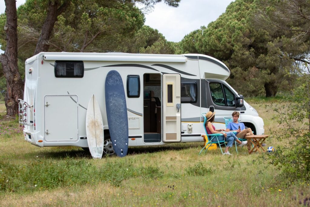 Couple at Class C RV with Surfboards